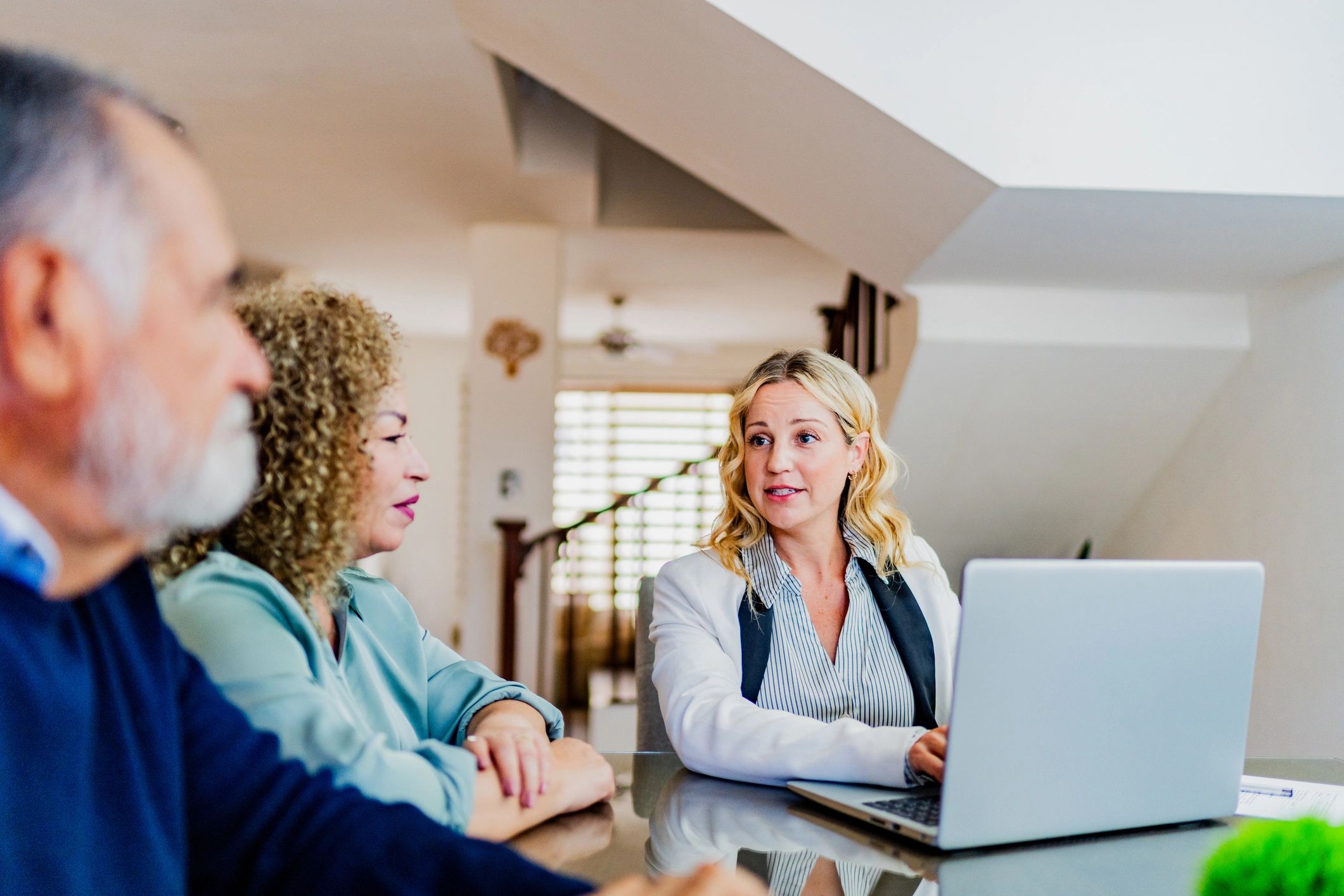 Financial planning conversation around a laptop